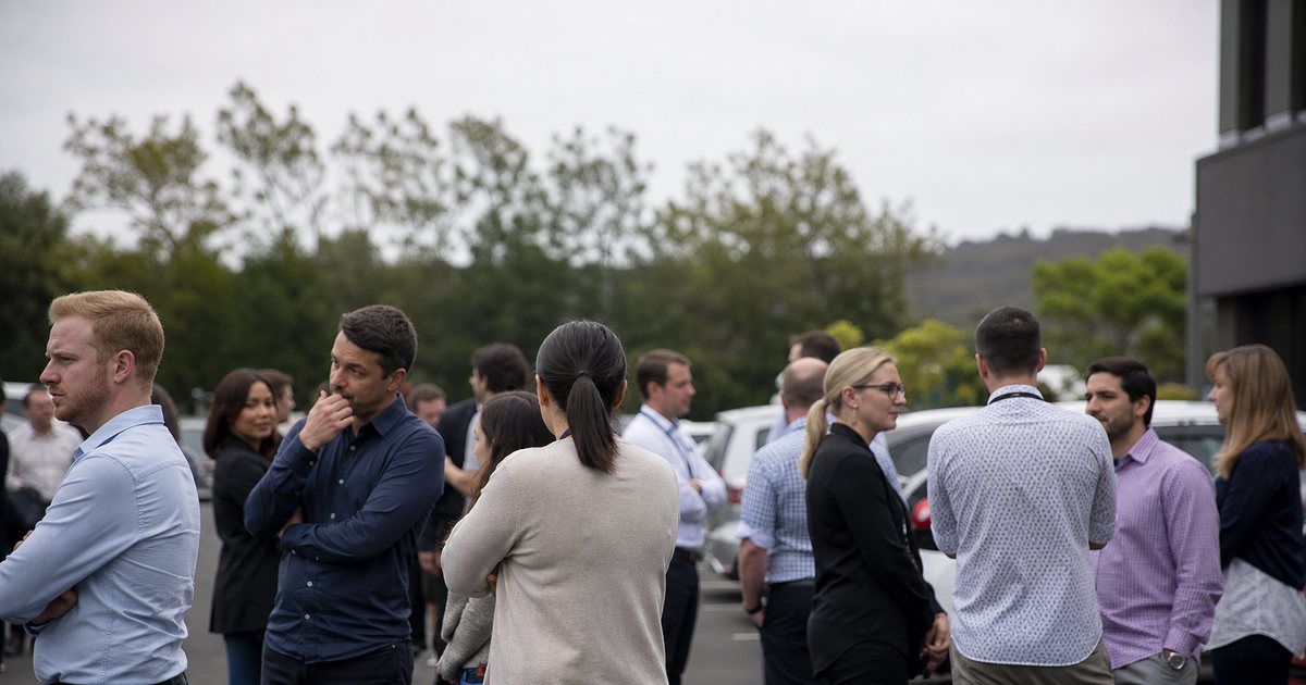 How do you evacuate a building safely using a real-time visitor sign-in roster?